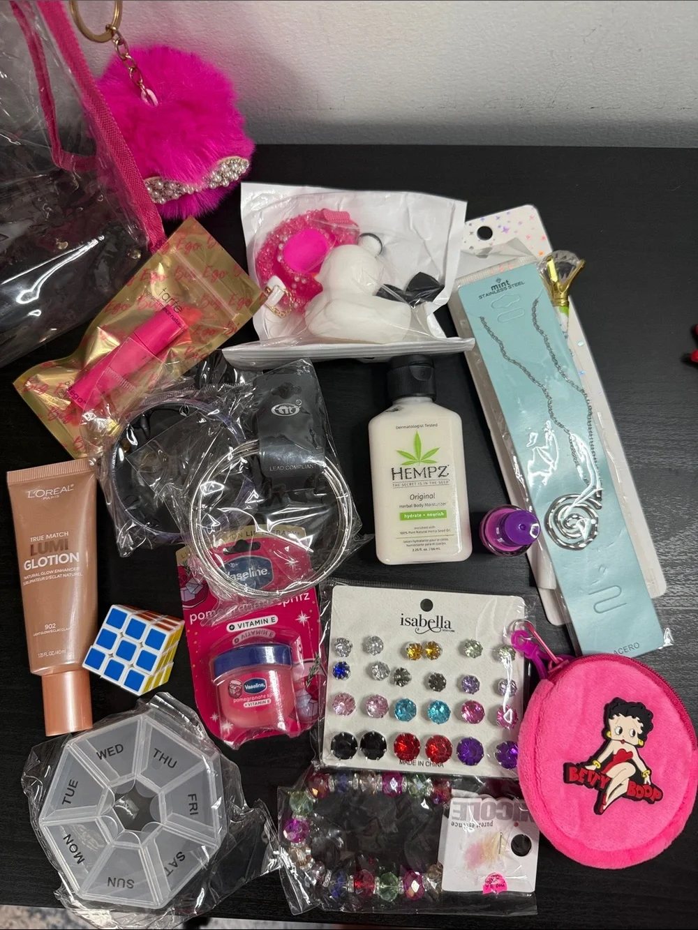 Clear Cosmetic Pouch with Hot Pink Trim and Pom Charm filled with goodies